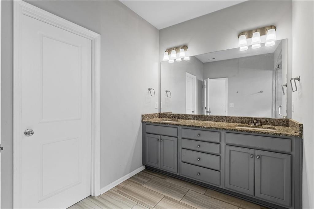 2787 Pearl Rdg Trace Buford, GA 30519 - Photo 44 of 52 a bathroom with a granite countertop double vanity sink and a mirror