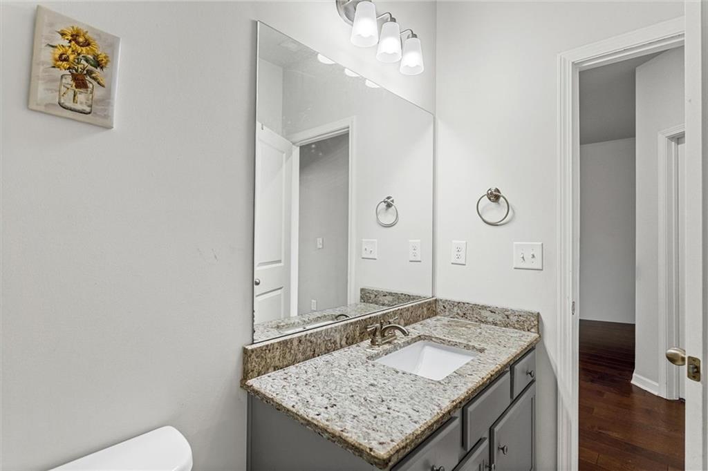 2787 Pearl Rdg Trace Buford, GA 30519 - Photo 47 of 52 a bathroom with a granite countertop sink and a mirror