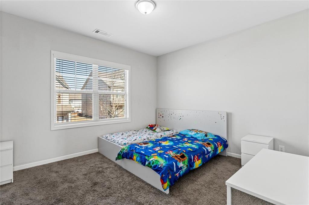 2787 Pearl Rdg Trace Buford, GA 30519 - Photo 48 of 52 a bedroom with a bed and a window