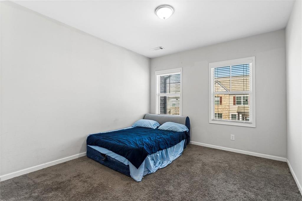 2787 Pearl Rdg Trace Buford, GA 30519 - Photo 51 of 52 a spacious bedroom with a bed and a window
