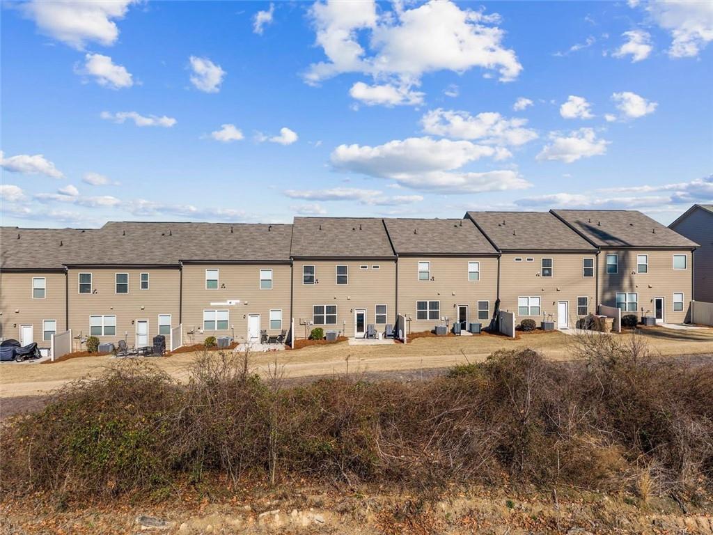 2787 Pearl Rdg Trace Buford, GA 30519 - Photo 10 of 52 a front view of a building with lot of cars parked