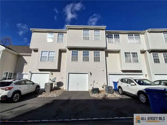 a view of staircase with wooden floor and white walls
