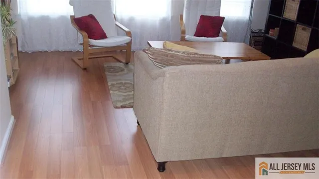 a view of a room with furniture and wooden floor