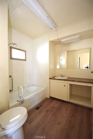 a bathroom with a granite countertop toilet a sink and a bathtub