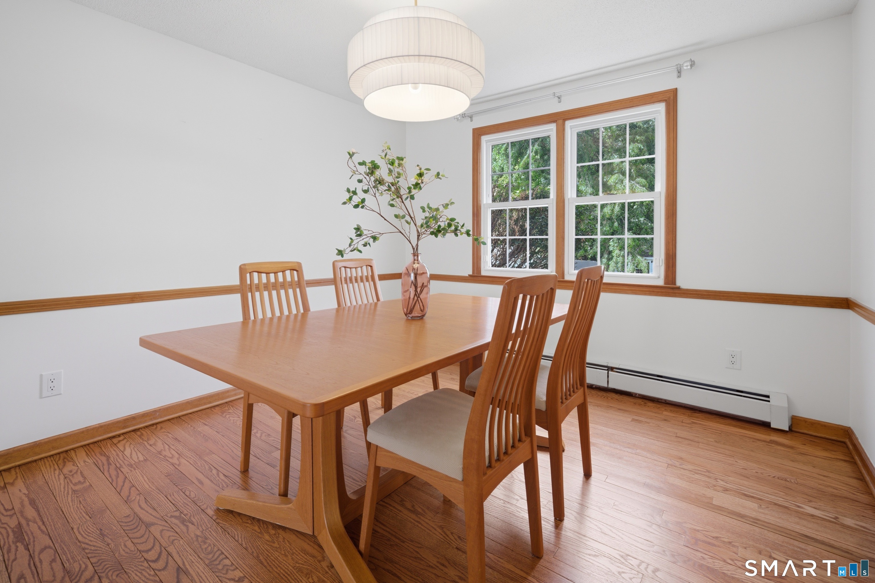 211 Valley View Road Manchester, CT 06040 - Photo 16 of 39 a dining room with furniture a chandelier and wooden floor