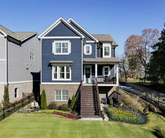 a front view of a house with yard swimming pool and outdoor seating