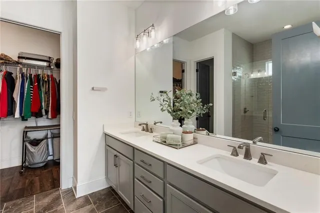 a large kitchen with stainless steel appliances kitchen island granite countertop a stove a sink dishwasher and a microwave with wooden floor