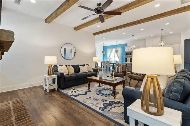 a living room with furniture and a potted plant