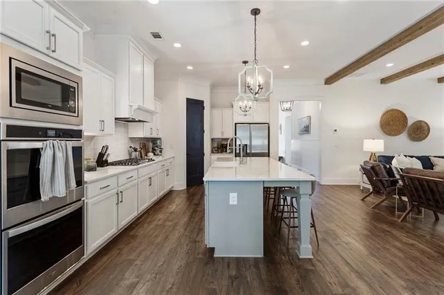 a living room with furniture a window and a flat screen tv