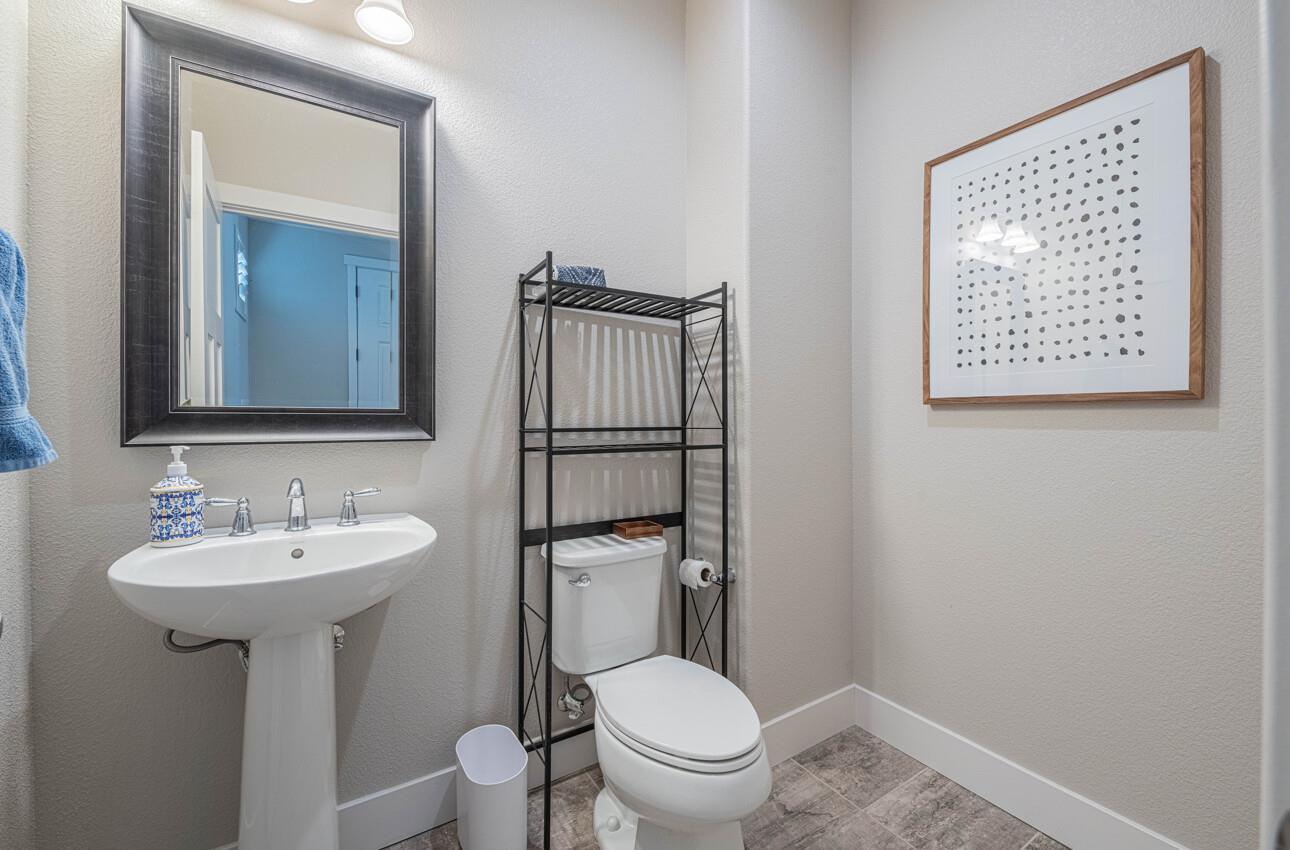 19130 Fallingwater Lane Marina, CA 93933 - Photo 14 of 43 a bathroom with a toilet sink and mirror