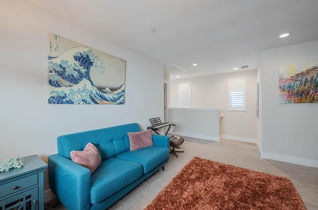 a view of a livingroom with furniture and a window