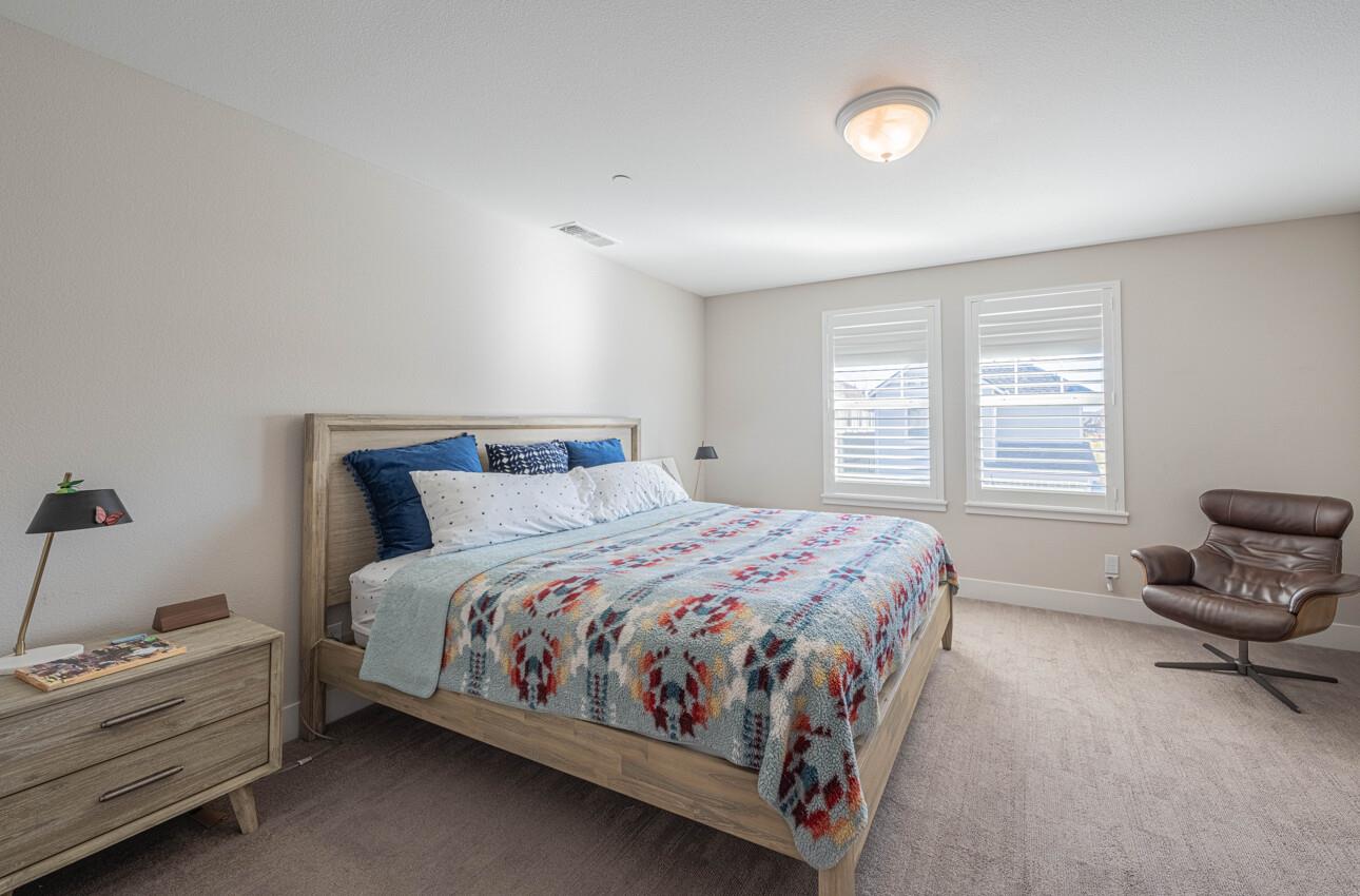 19130 Fallingwater Lane Marina, CA 93933 - Photo 19 of 43 a bedroom with a bed and window