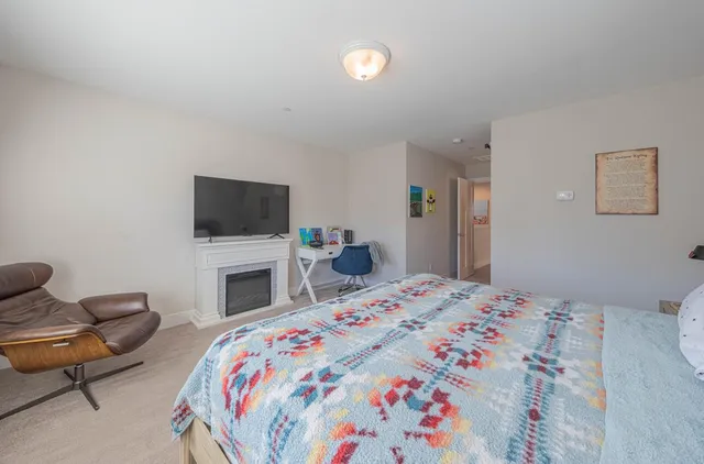 a bedroom with a bed and chair