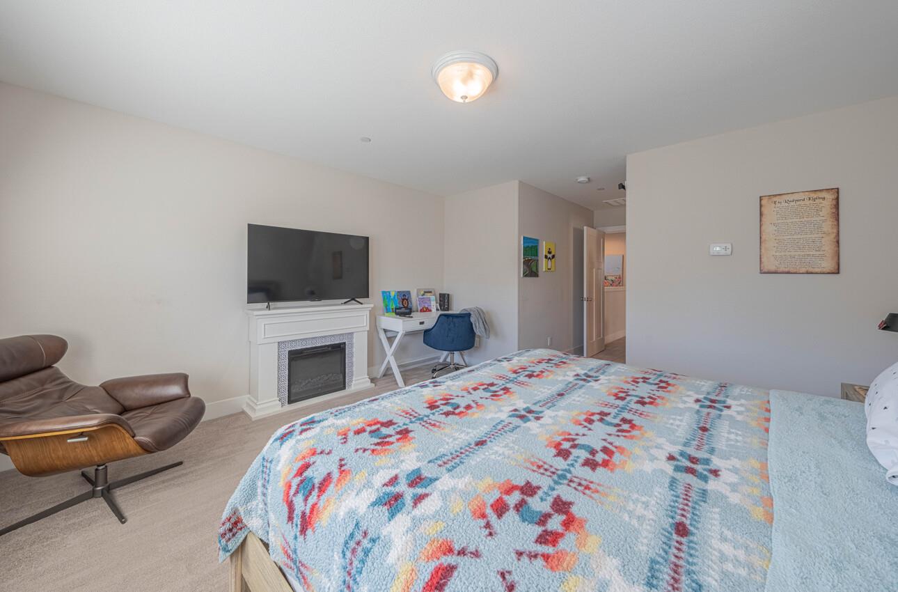 19130 Fallingwater Lane Marina, CA 93933 - Photo 20 of 43 a bedroom with a bed and a flat screen tv