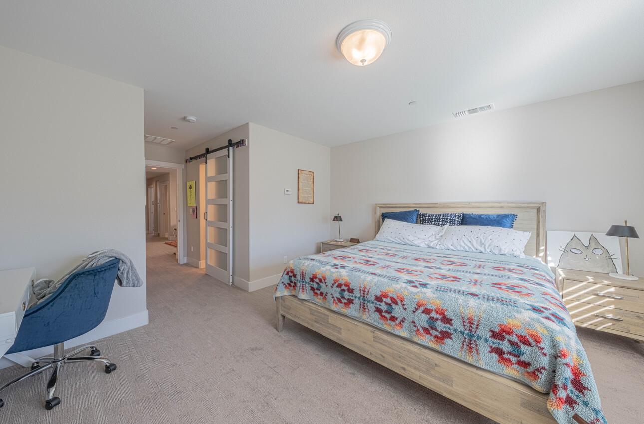 19130 Fallingwater Lane Marina, CA 93933 - Photo 21 of 43 a bedroom with a bed and chair