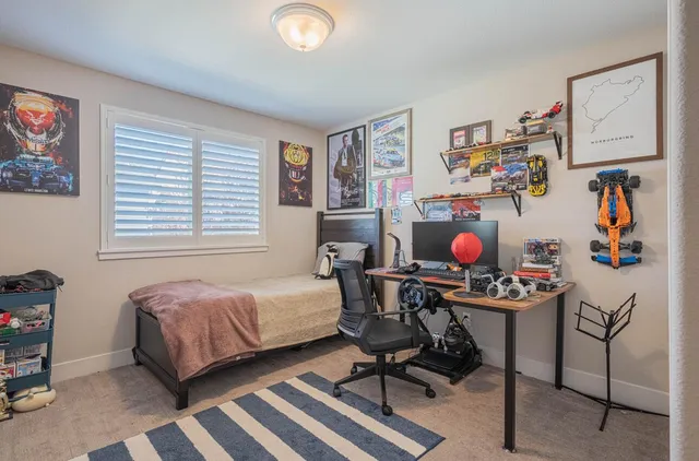a room with furniture and paintings on the wall