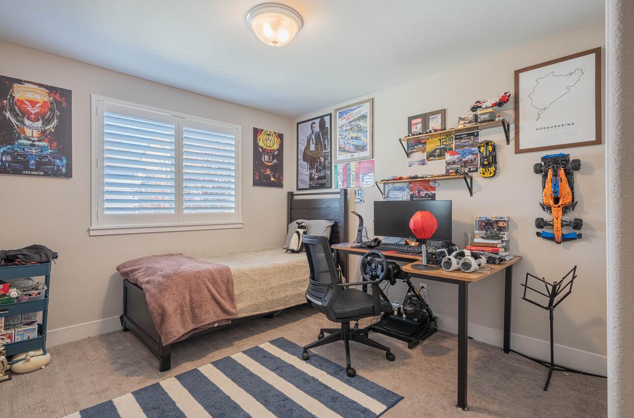 19130 Fallingwater Lane Marina, CA 93933 - Photo 26 of 43 a bedroom with a bed and workspace