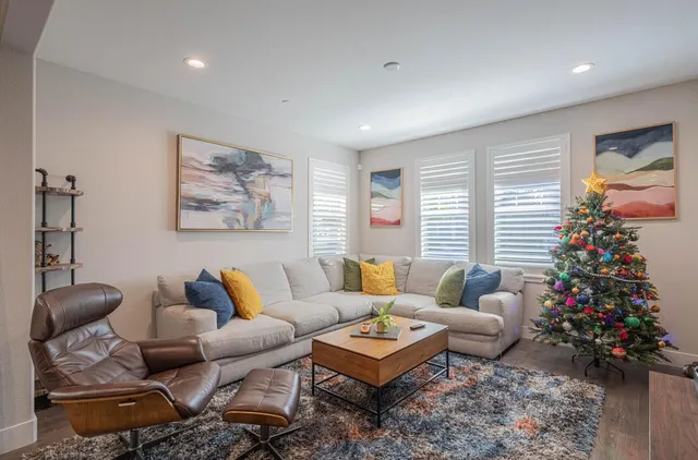 a living room with furniture potted plant and a window