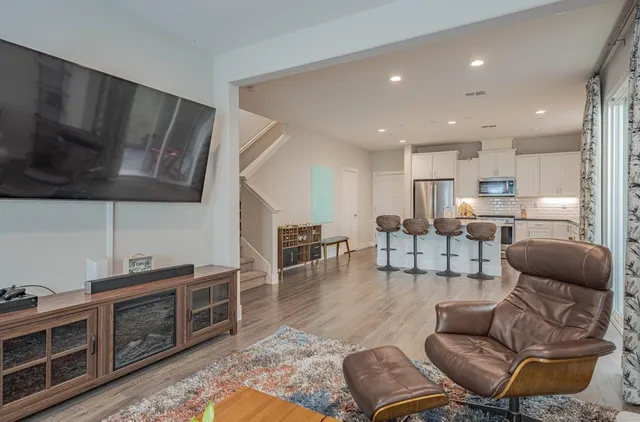 a living room with furniture or kitchen view and a wooden floor