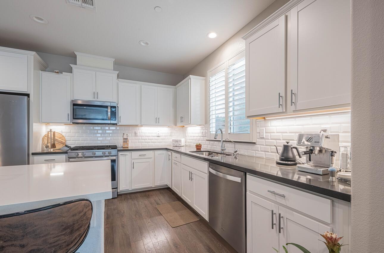 19130 Fallingwater Lane Marina, CA 93933 - Photo 10 of 43 a kitchen with granite countertop cabinets stainless steel appliances a sink and a window