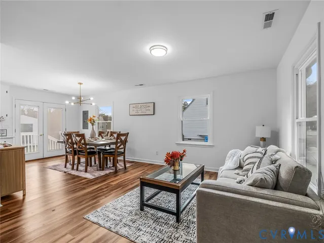 a living room with furniture and wooden floor
