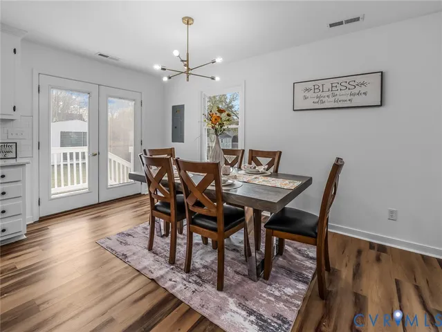 a view of a dining room with furniture wooden floor and chandelier