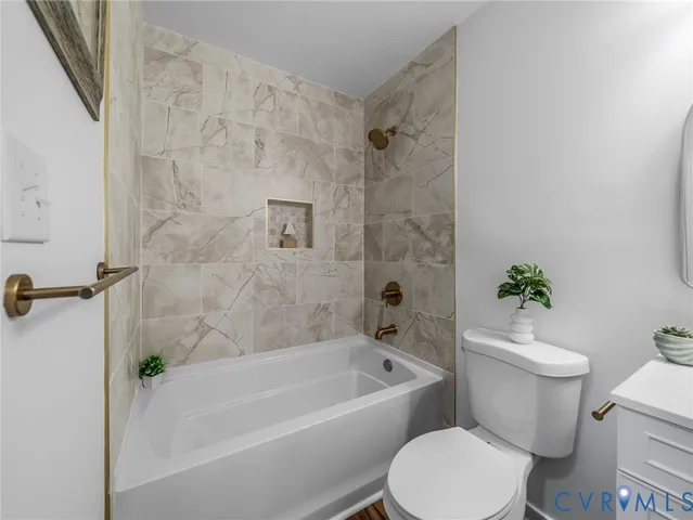 a white toilet sitting next to a bath tub