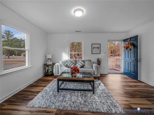 a living room with furniture rug and window