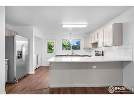 a kitchen with a sink stove and cabinets