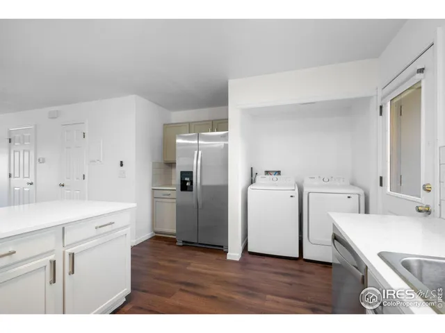 a kitchen with a sink dishwasher a refrigerator and cabinets
