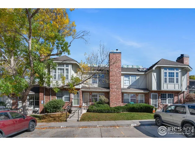 a front view of a residential apartment building with a yard