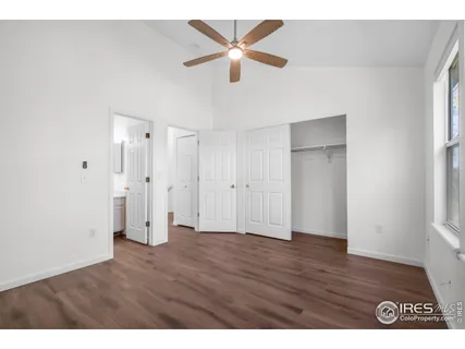 a bedroom with a bed a window and a chandelier