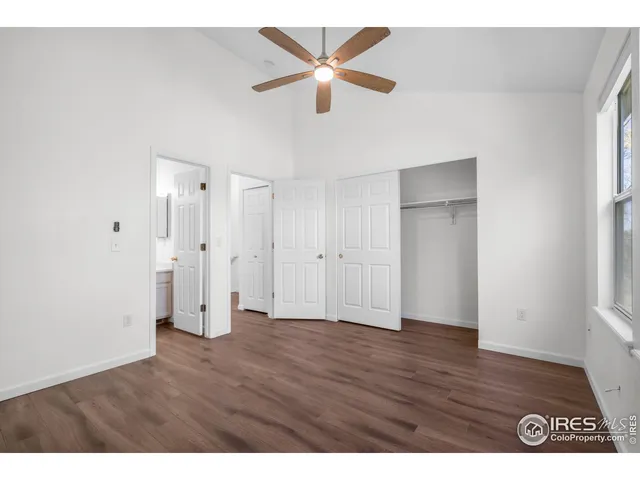 a bedroom with a bed a window and a chandelier