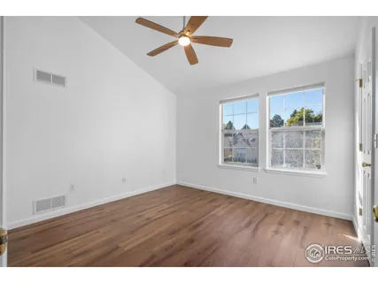 a bedroom with a bed a dresser and a window