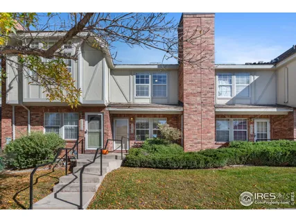 a view of a house with a chairs and table in a patio