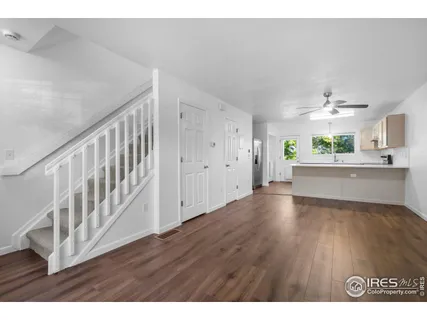 a view interior of a house wooden floor an entryway and a living room