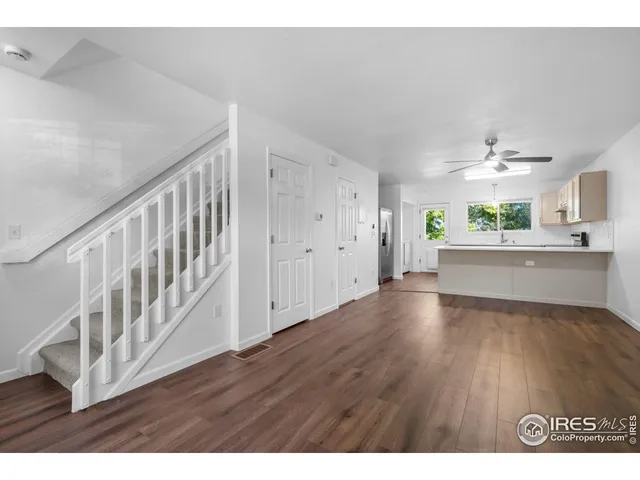 a view interior of a house wooden floor an entryway and a living room