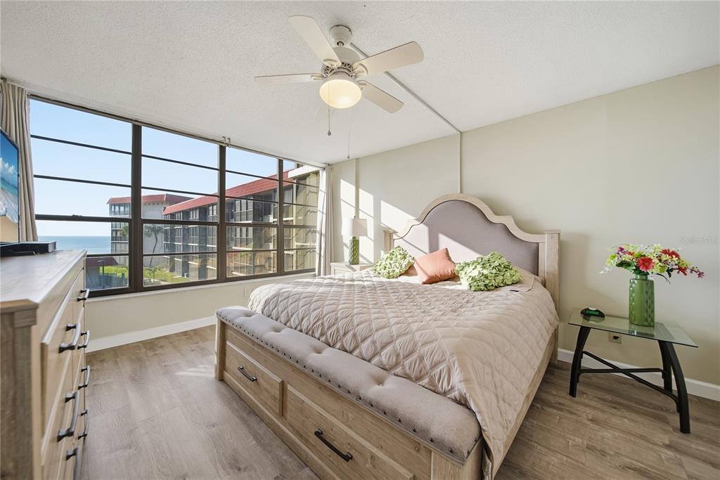 17580 Gulf Boulevard, Unit 302 Redington Shores, FL 33708 - Photo 18 of 37 a bed room with a bed and a chair