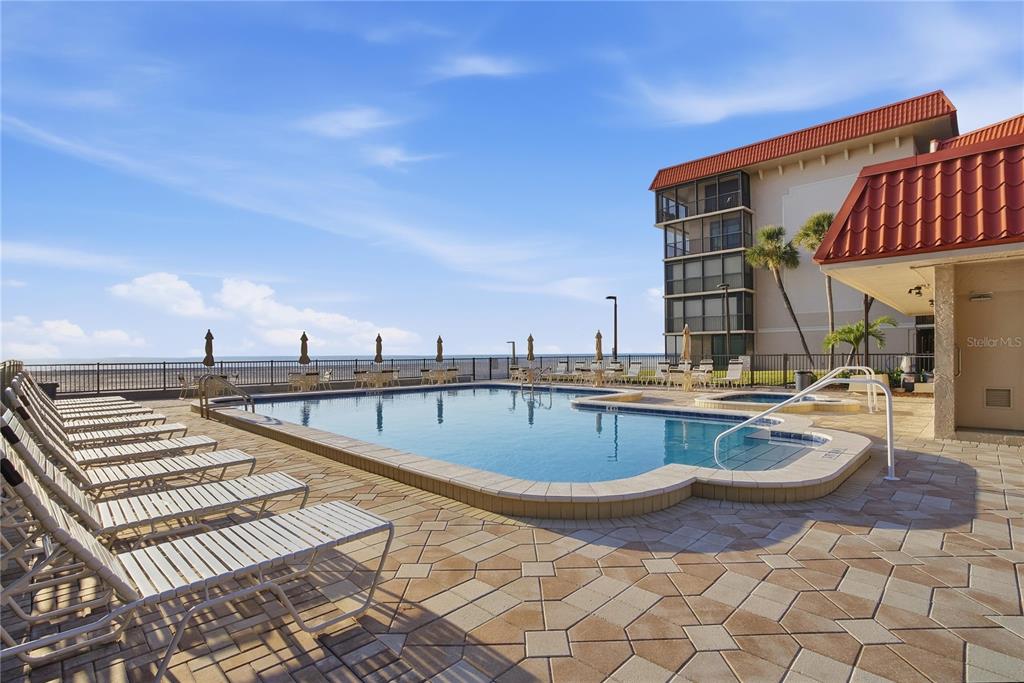 17580 Gulf Boulevard, Unit 302 Redington Shores, FL 33708 - Photo 29 of 37 a view of a swimming pool with lounge chair