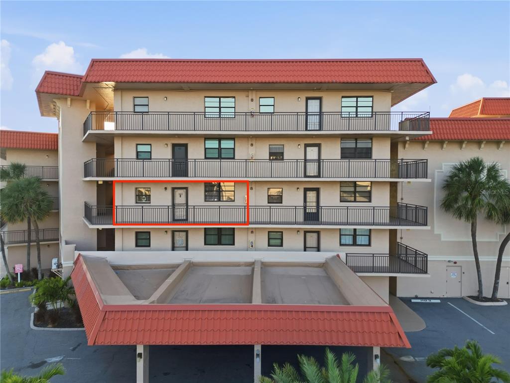 17580 Gulf Boulevard, Unit 302 Redington Shores, FL 33708 - Photo 4 of 37 a front view of a building with a garden