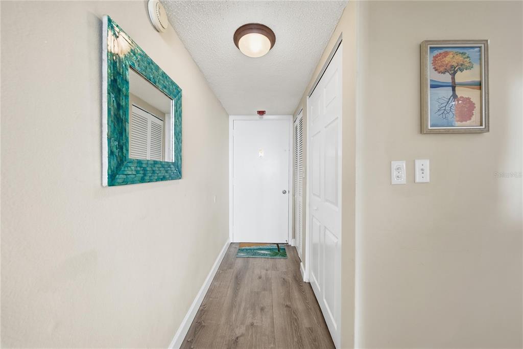 17580 Gulf Boulevard, Unit 302 Redington Shores, FL 33708 - Photo 5 of 37 a view of a hallway with wooden floor
