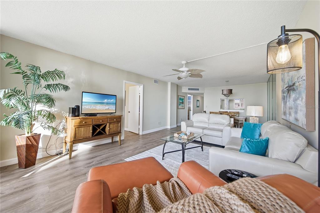 17580 Gulf Boulevard, Unit 302 Redington Shores, FL 33708 - Photo 6 of 37 a living room with furniture a flat screen tv and a potted plant