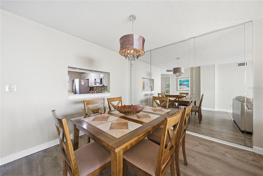 17580 Gulf Boulevard, Unit 302 Redington Shores, FL 33708 - Photo 9 of 37 a view of a dining room with furniture and wooden floor