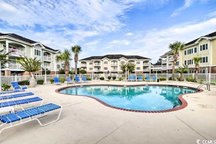 4864 Carnation Circle, Unit 204 Myrtle Beach, SC 29577 - Photo 13 of 13 Community pool with a patio area
