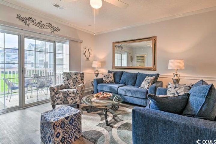 4864 Carnation Circle, Unit 204 Myrtle Beach, SC 29577 - Photo 4 of 13 Living room with wood finished floors, ornamental molding, and a ceiling fan