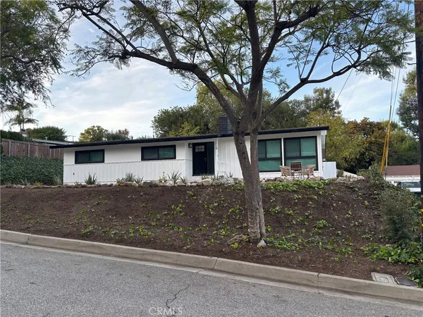 front view of a house with a tree
