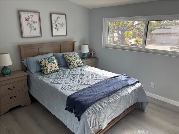 a bed sitting in a bedroom next to a window