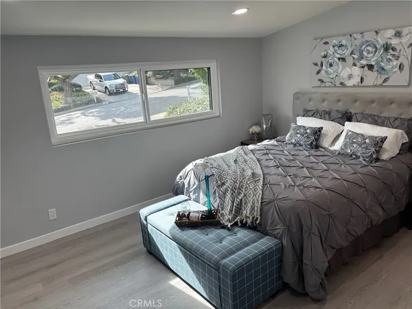 a bedroom with a bed and window