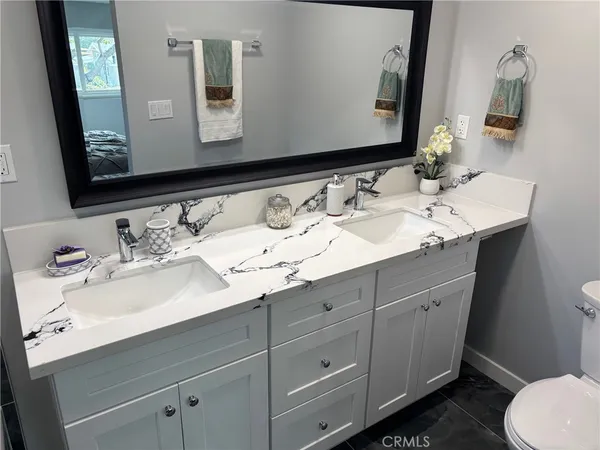 a bathroom with a double vanity sink and a mirror