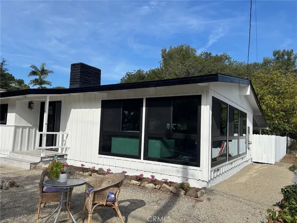 a backyard of a house with table and chairs